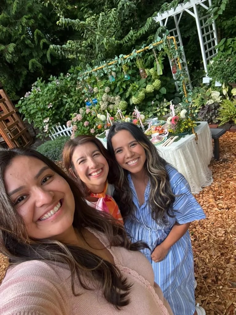 A behind-the-scenes group selfie beside the completed garden table