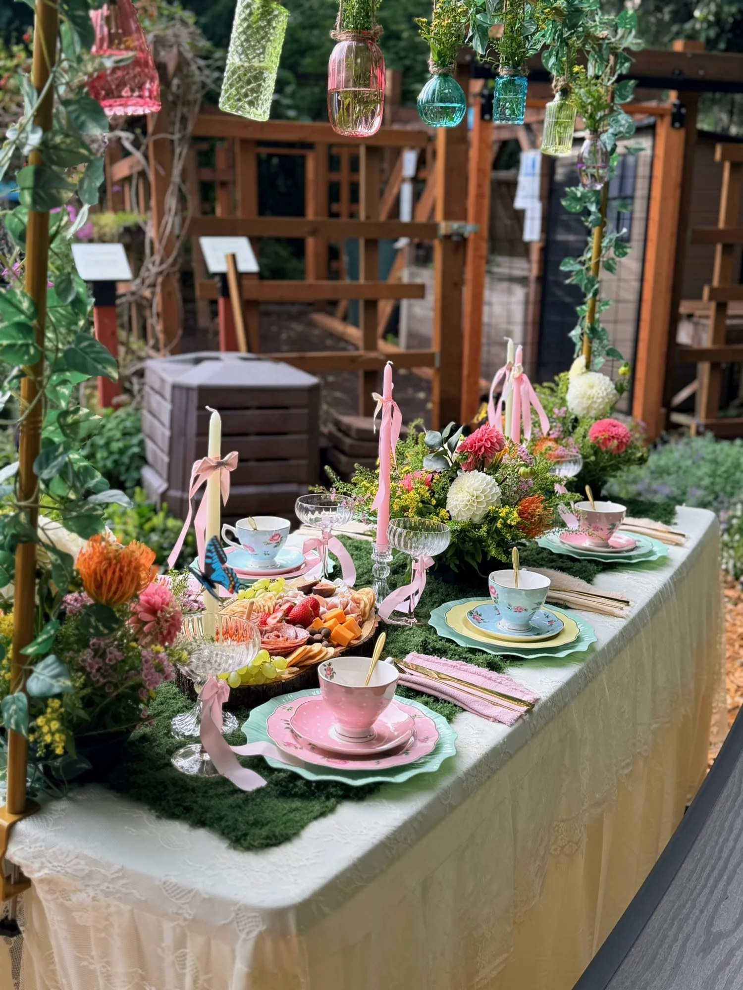 Garden table with tea settings and a charcuterie board