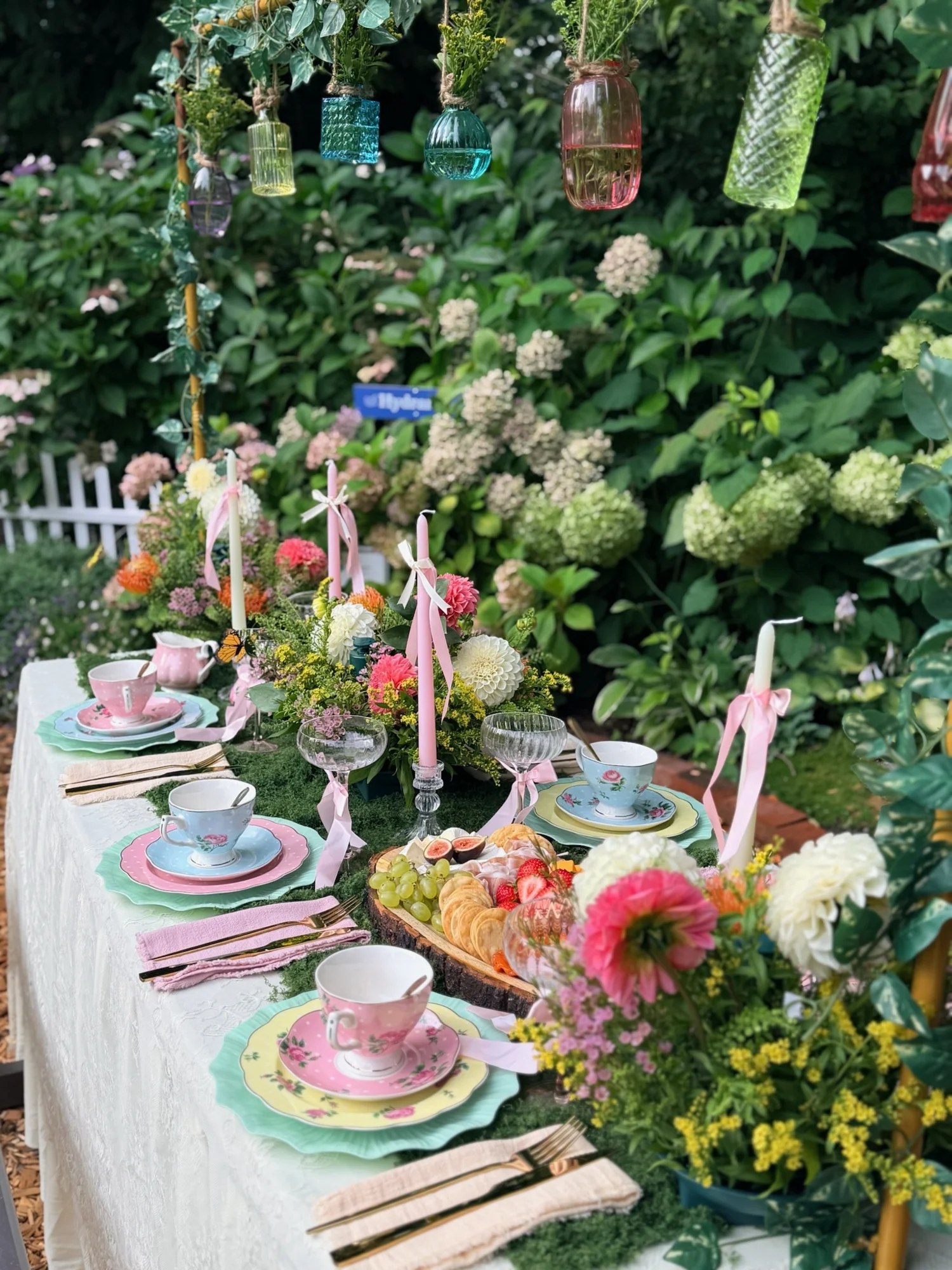 Floral arrangements and charcuterie along the tea table