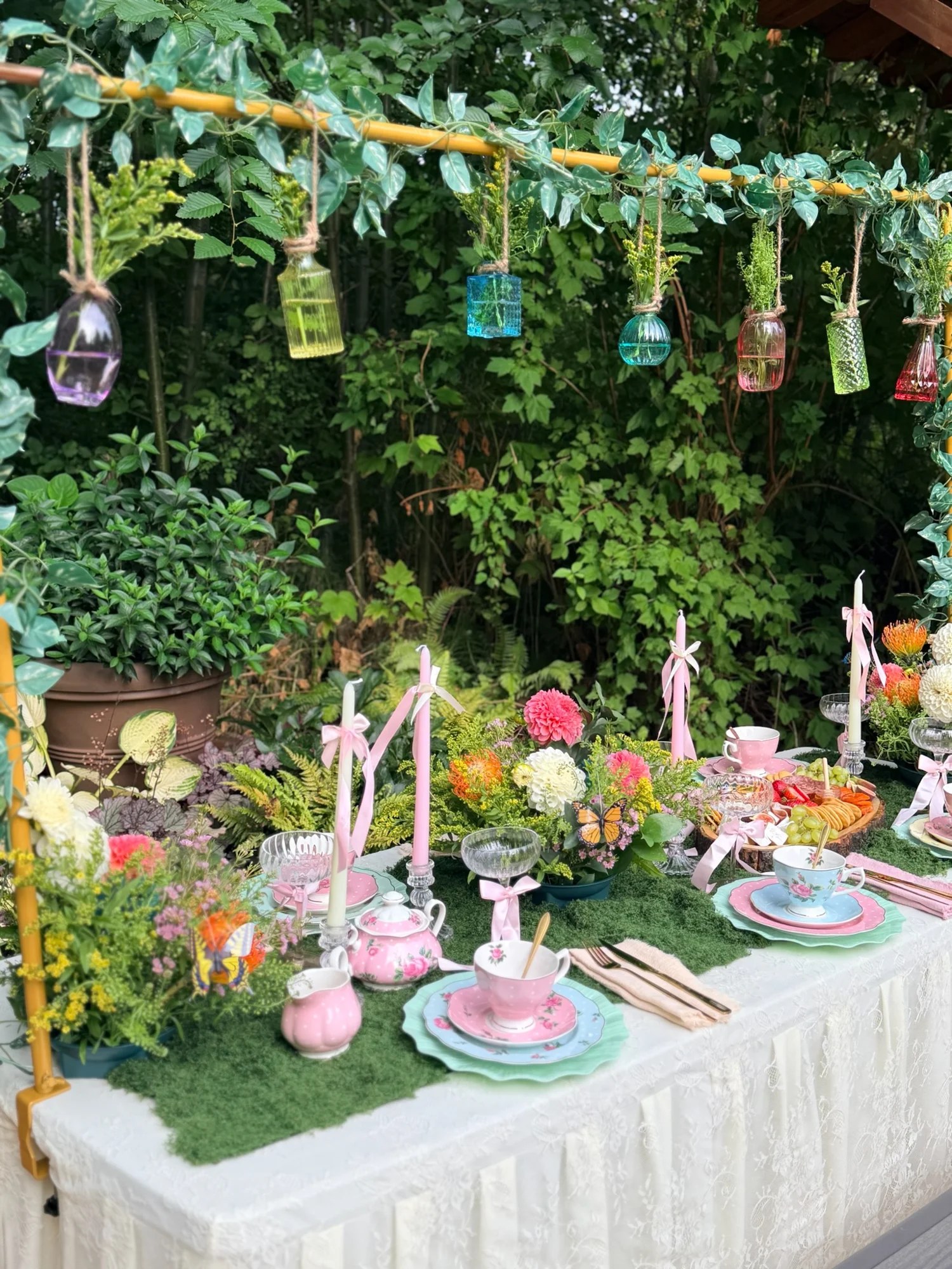 Hanging colorful glass vases above the garden tablescape