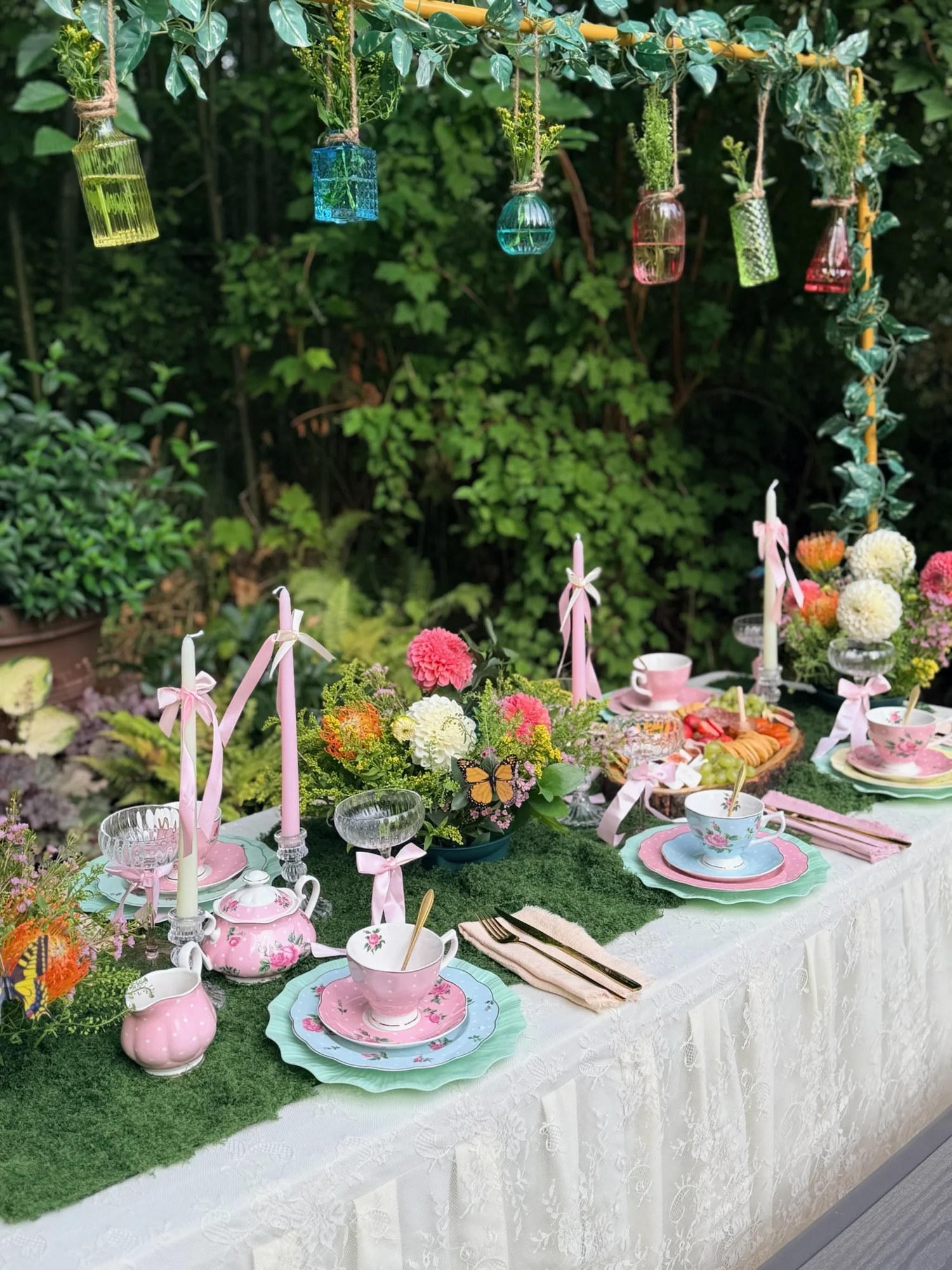 Pink and blue china arranged along a green table runner