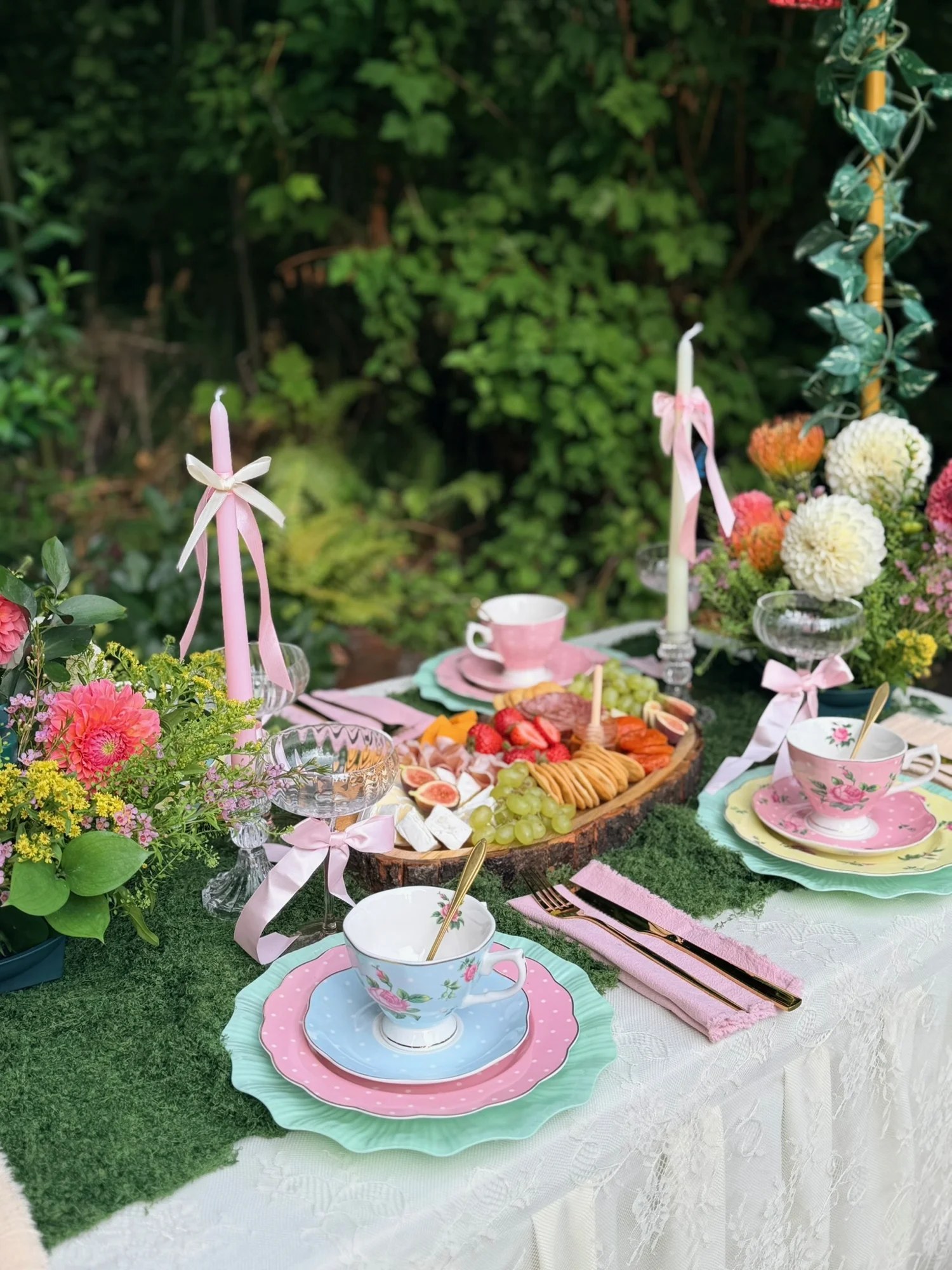 Grazefully Gathered charcuterie and cheese board surrounded by floral tea cups